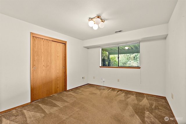 unfurnished bedroom with carpet flooring and a closet