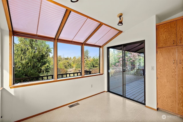 unfurnished sunroom with a wealth of natural light and vaulted ceiling