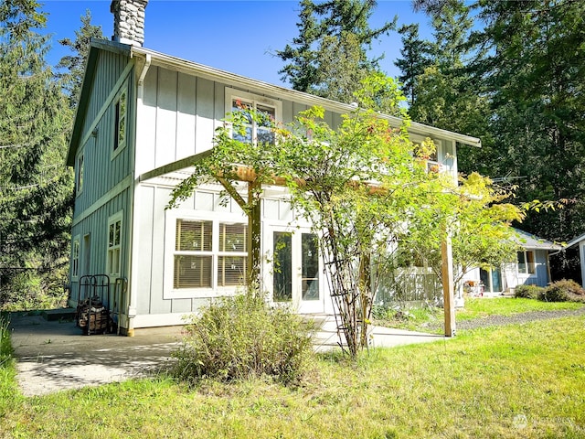 rear view of property with a yard