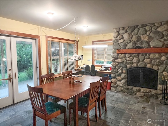 dining area featuring a fireplace and french doors