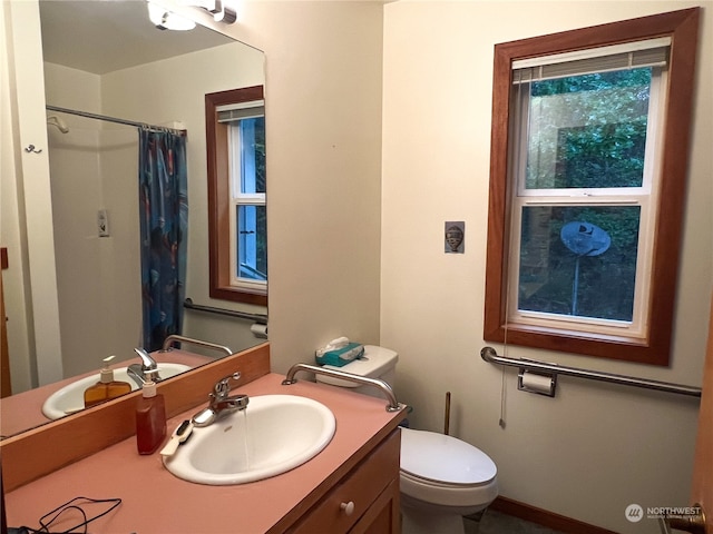 bathroom with vanity, toilet, and a shower with shower curtain