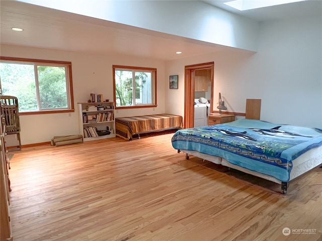 bedroom with light hardwood / wood-style floors and a skylight