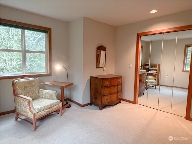 sitting room featuring light colored carpet