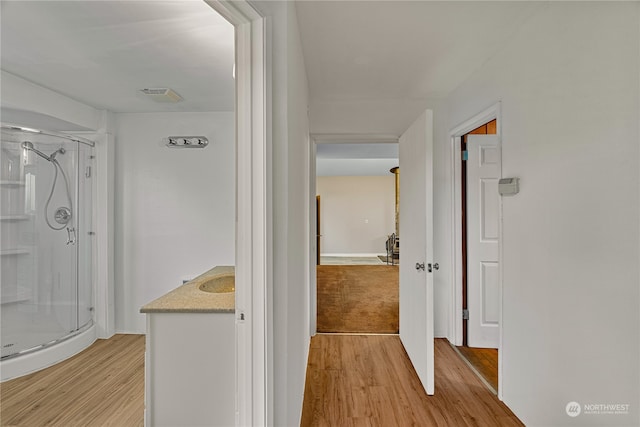 hall with light hardwood / wood-style floors