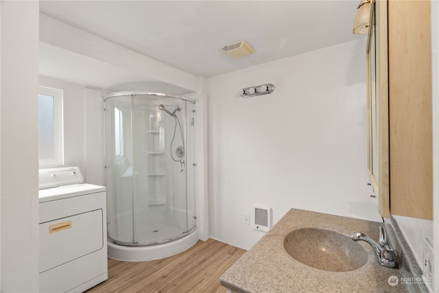 bathroom with walk in shower, washer / clothes dryer, vanity, and hardwood / wood-style floors