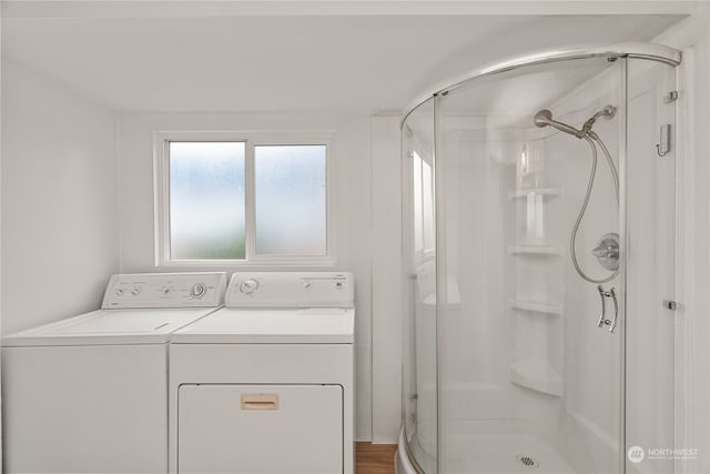 clothes washing area with washer and clothes dryer