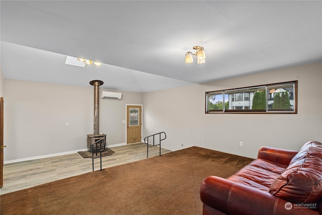 living room featuring an AC wall unit, a wood stove, and hardwood / wood-style flooring