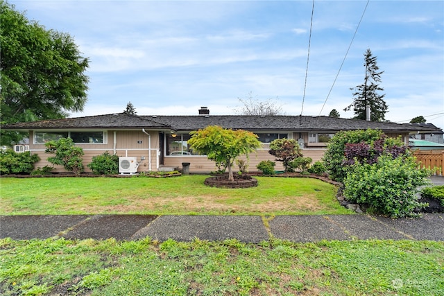 ranch-style house with a front lawn and ac unit