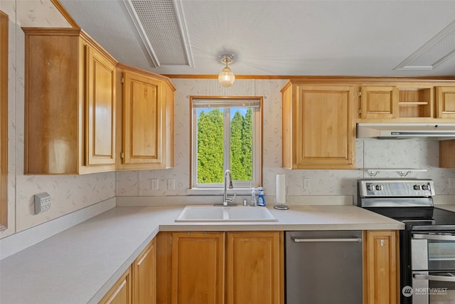 kitchen featuring light brown cabinets, appliances with stainless steel finishes, and sink