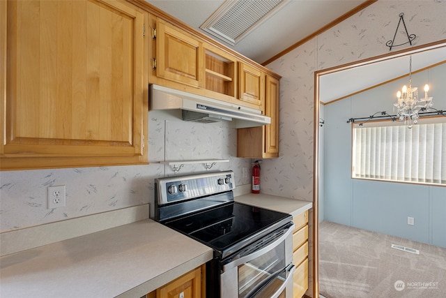 kitchen featuring pendant lighting, stainless steel range with electric stovetop, light colored carpet, a notable chandelier, and crown molding