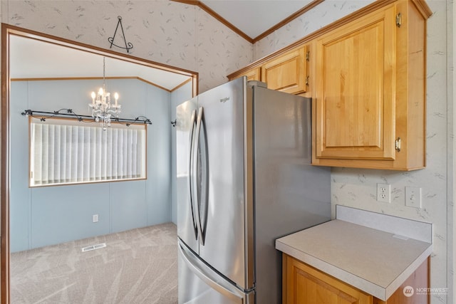 kitchen featuring stainless steel refrigerator, an inviting chandelier, decorative light fixtures, ornamental molding, and light colored carpet