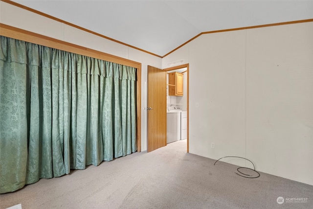 carpeted empty room with lofted ceiling and crown molding