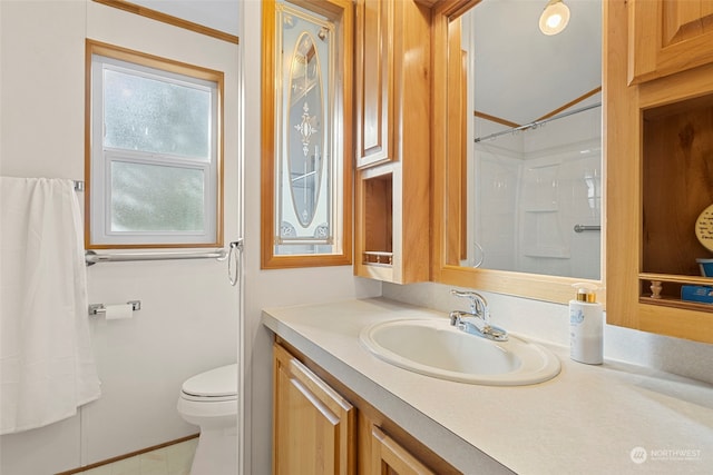 bathroom featuring vanity, a shower, toilet, and tile patterned floors