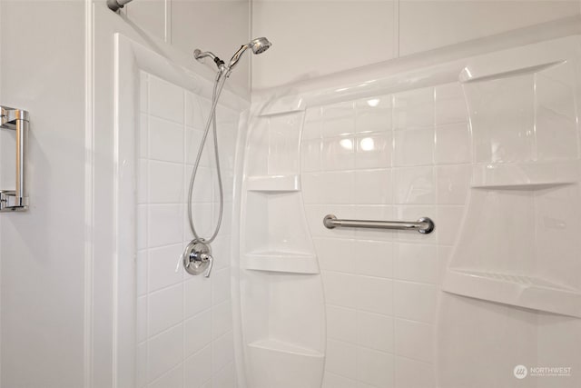 bathroom with tiled shower