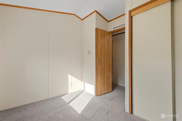 225 NE Ernst St Unit 61, Oak Harbor, WA 98277 - unfurnished bedroom featuring carpet flooring, a closet, vaulted ceiling, and crown molding
