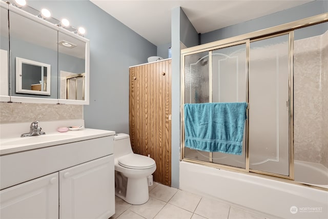 full bathroom featuring enclosed tub / shower combo, tile patterned flooring, vanity, and toilet