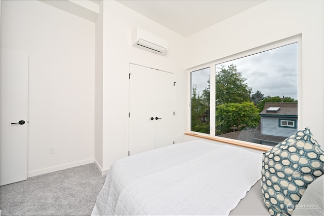 bedroom with carpet floors, an AC wall unit, and a closet