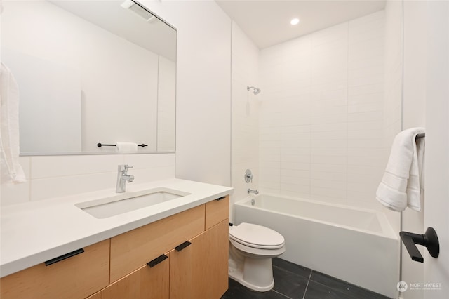 full bathroom with vanity, tiled shower / bath combo, toilet, and tile patterned flooring