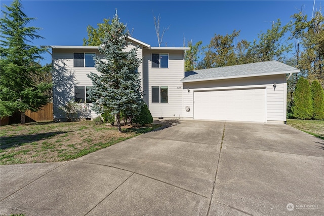 view of front of property featuring a front yard and a garage