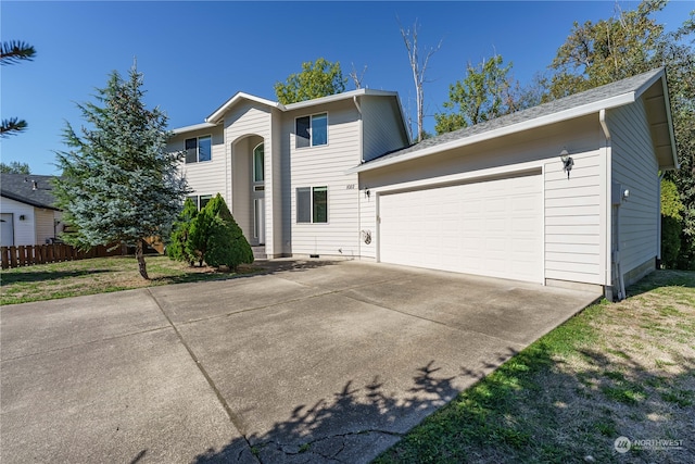 view of front of house featuring a garage and a front yard