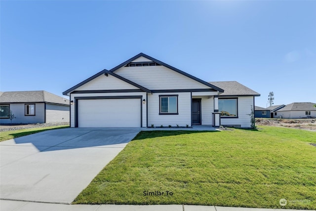 view of front of home with a front yard and a garage