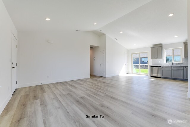 unfurnished living room featuring light wood-type flooring and lofted ceiling