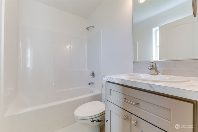 full bathroom with shower / washtub combination, vanity, and toilet