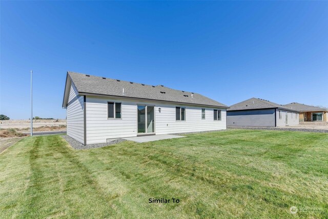 back of property featuring a yard and a patio area