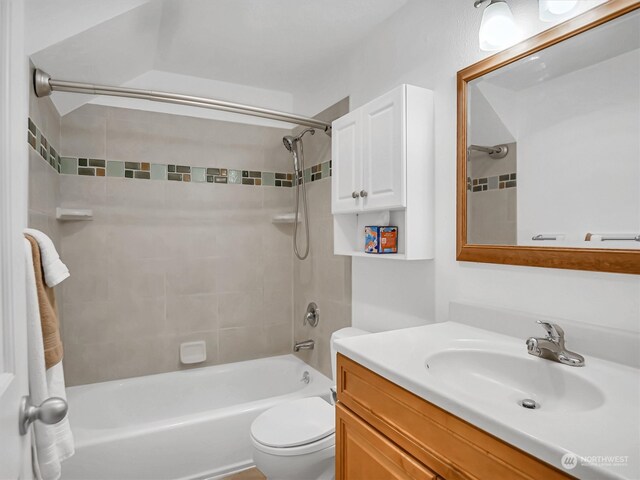 full bathroom with vanity, toilet, and tiled shower / bath