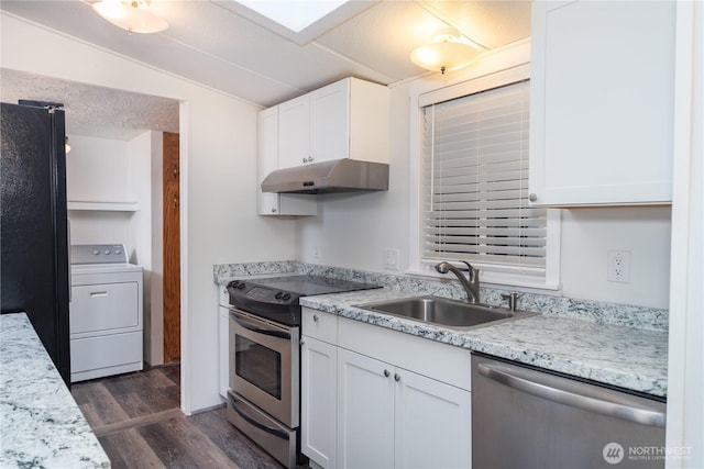 kitchen featuring appliances with stainless steel finishes, washer / clothes dryer, under cabinet range hood, white cabinetry, and a sink