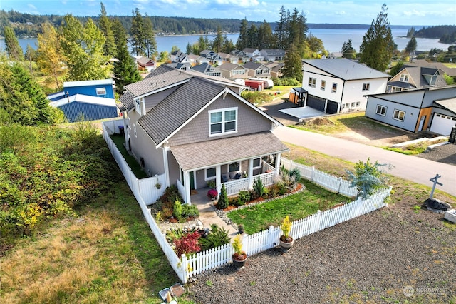 view of front of home with a water view, a porch, and a garage