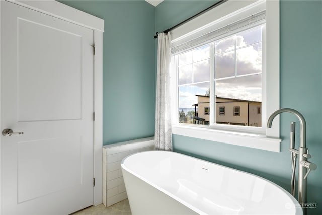 bathroom featuring a bathing tub and tile walls