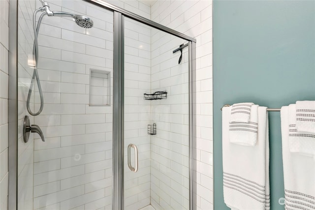 bathroom with a shower with shower door