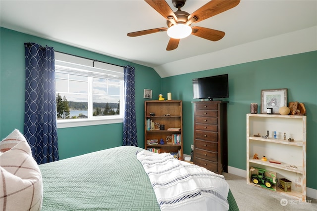 carpeted bedroom featuring lofted ceiling and ceiling fan