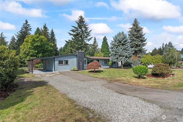 view of front facade featuring a front yard and a carport