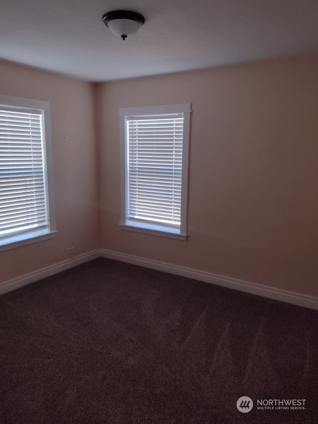 empty room featuring dark colored carpet