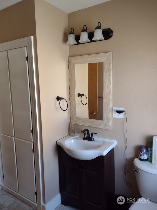 bathroom with vanity and toilet