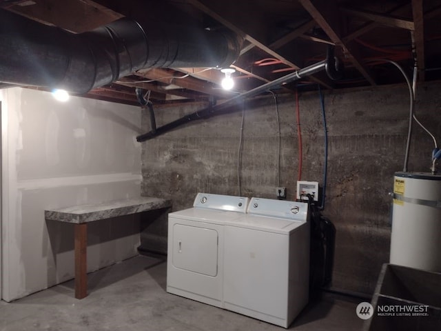 clothes washing area with strapped water heater and independent washer and dryer