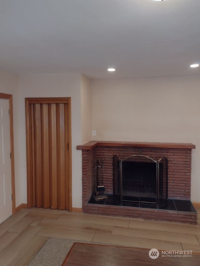 interior space featuring wood-type flooring and a fireplace