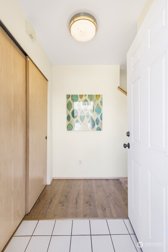 unfurnished bedroom with light hardwood / wood-style flooring and a closet