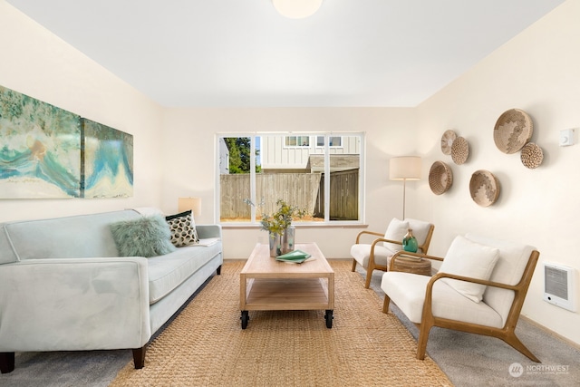 living room featuring light carpet and heating unit