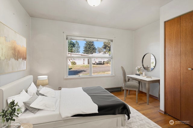 bedroom with a closet and hardwood / wood-style flooring