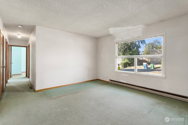 carpeted empty room with a textured ceiling and a baseboard radiator