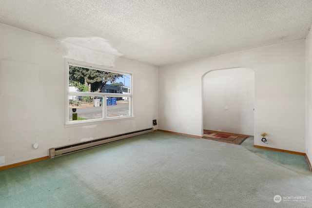 carpeted spare room featuring a textured ceiling and a baseboard radiator