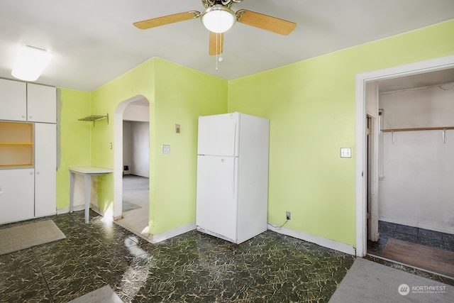 interior space with ceiling fan, a closet, and white fridge