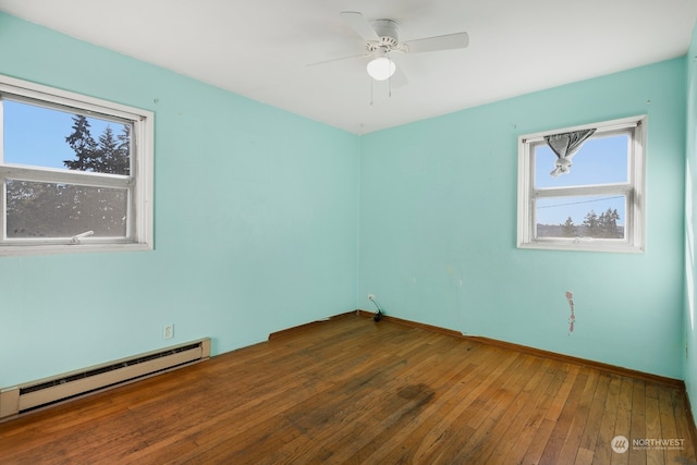 empty room with ceiling fan, hardwood / wood-style flooring, and baseboard heating