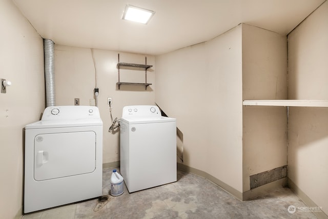 clothes washing area featuring washer and clothes dryer