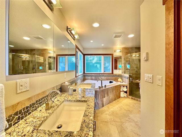 bathroom featuring independent shower and bath and vanity