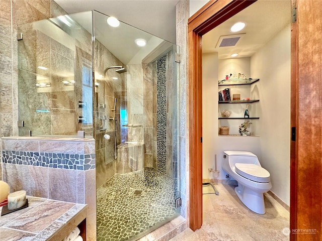 bathroom with baseboards, toilet, a shower stall, visible vents, and built in shelves