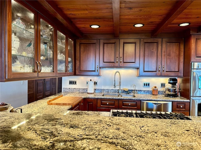 kitchen featuring beamed ceiling, wooden ceiling, a sink, and appliances with stainless steel finishes